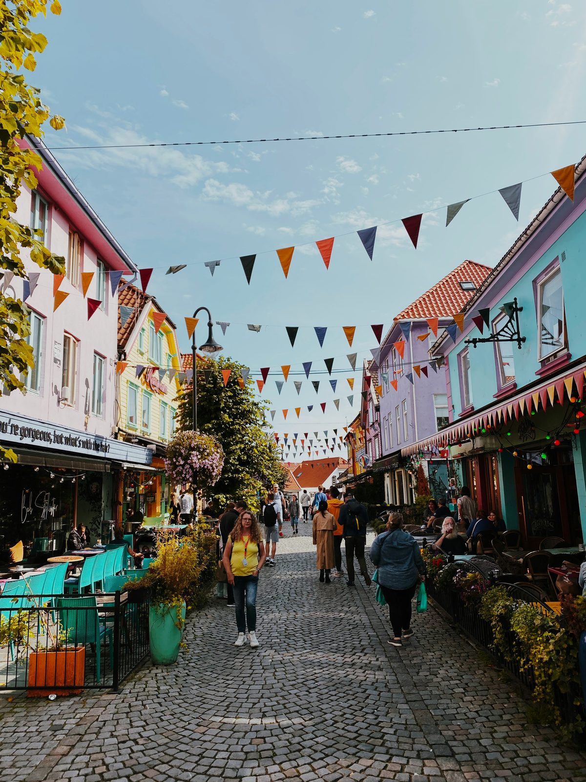 Fargegaten i Stavanger med knallmalte fasader og vimpler spent over brosteinsgata