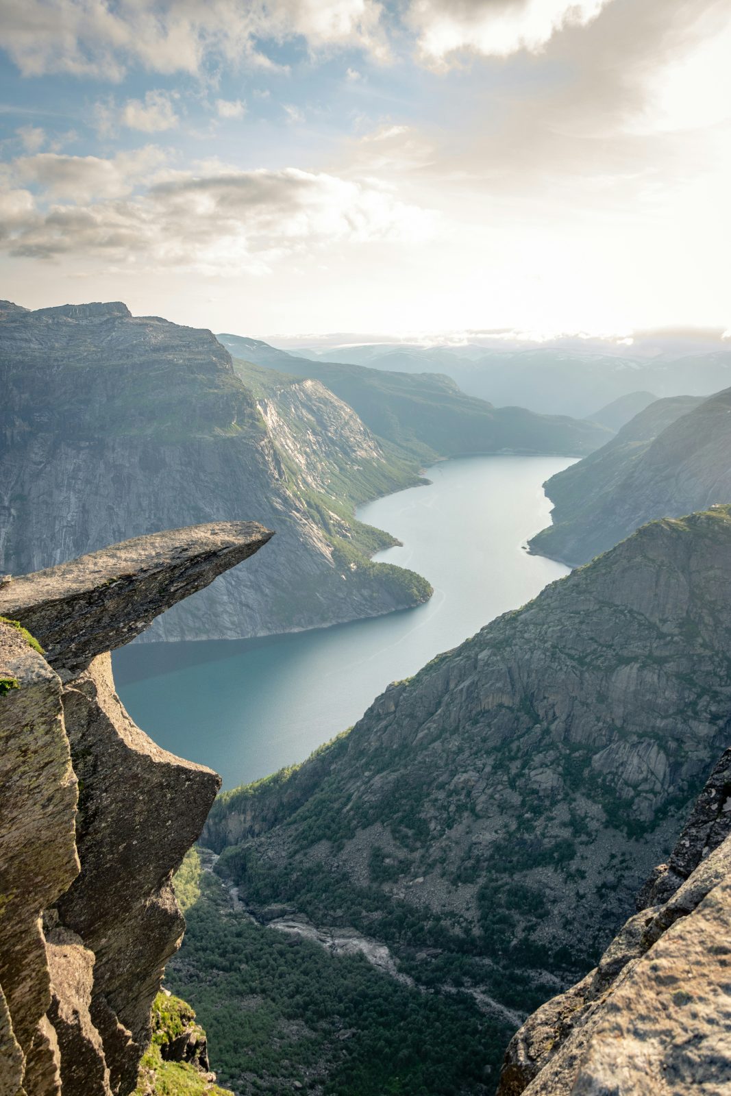 Trolltunga i lav kveldssol, med Ringedalsvatnet som slynger seg mellom fjellene mot horisonten